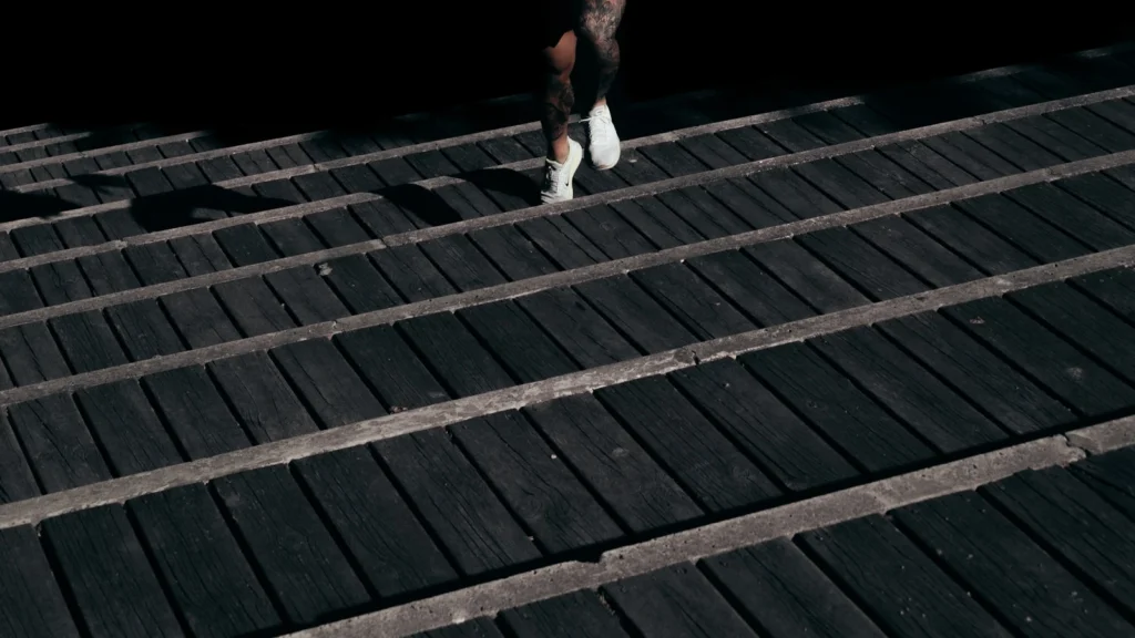 Person climbing dark stairs as a metaphor for slowing down before weight-loss medication comparison decisions